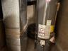 Utility room with gas water heater and heating unit