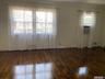 Living room featuring ornamental molding and dark wood-style floors