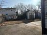 Fenced backyard featuring a storage shed