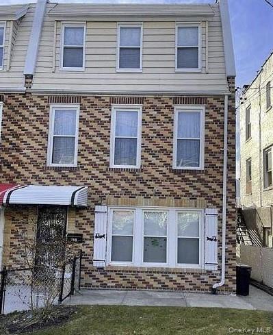 Rear view of house with brick siding