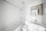 Bathroom featuring vanity, tub / shower combination, and tile walls