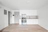 Kitchen featuring stainless steel electric range oven, electric panel, white cabinetry, light wood-type flooring, and tasteful backsplash