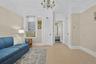 Sitting room featuring light wood-type flooring and a chandelier