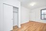 Unfurnished bedroom with light wood-style flooring, a closet, and an ornate ceiling