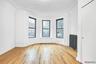 Spare room with radiator heating unit, crown molding, light wood-type flooring, and an ornate ceiling