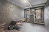 Dining area featuring brick wall, radiator heating unit, and tile patterned flooring