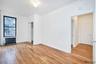 Unfurnished room with radiator, light wood-type flooring, and an ornate ceiling
