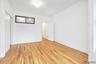 Unfurnished bedroom with an ornate ceiling, crown molding, and light wood-style flooring