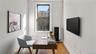 Office area featuring radiator heating unit and wood finished floors
