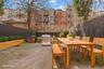 Fenced backyard featuring a patio, outdoor dining space, and area for grilling