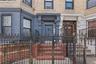 Property entrance with brick siding and a gate