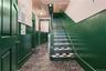Staircase with a textured ceiling and marble finish floors