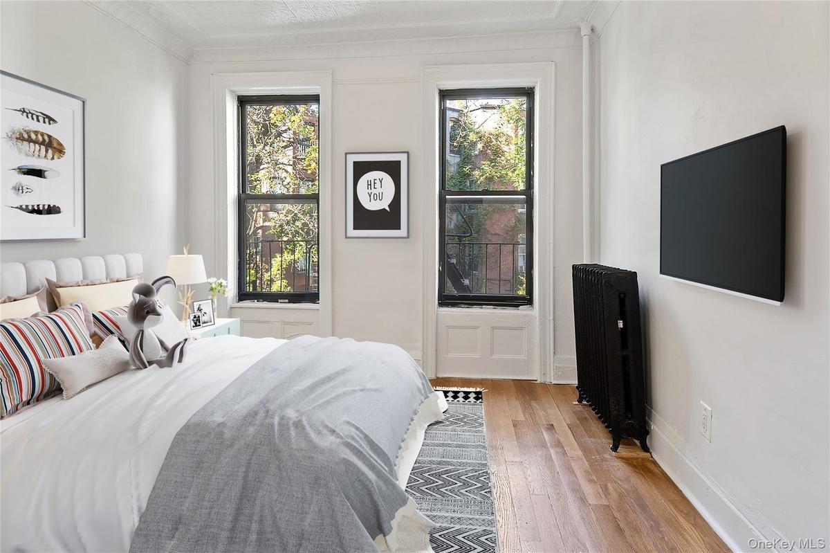 Bedroom featuring hardwood / wood-style floors and baseboards