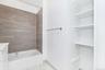 Bathroom featuring bathing tub / shower combination and baseboards