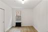 Empty room featuring radiator heating unit and light wood-style floors