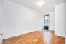 Empty room with radiator and light wood-style floors