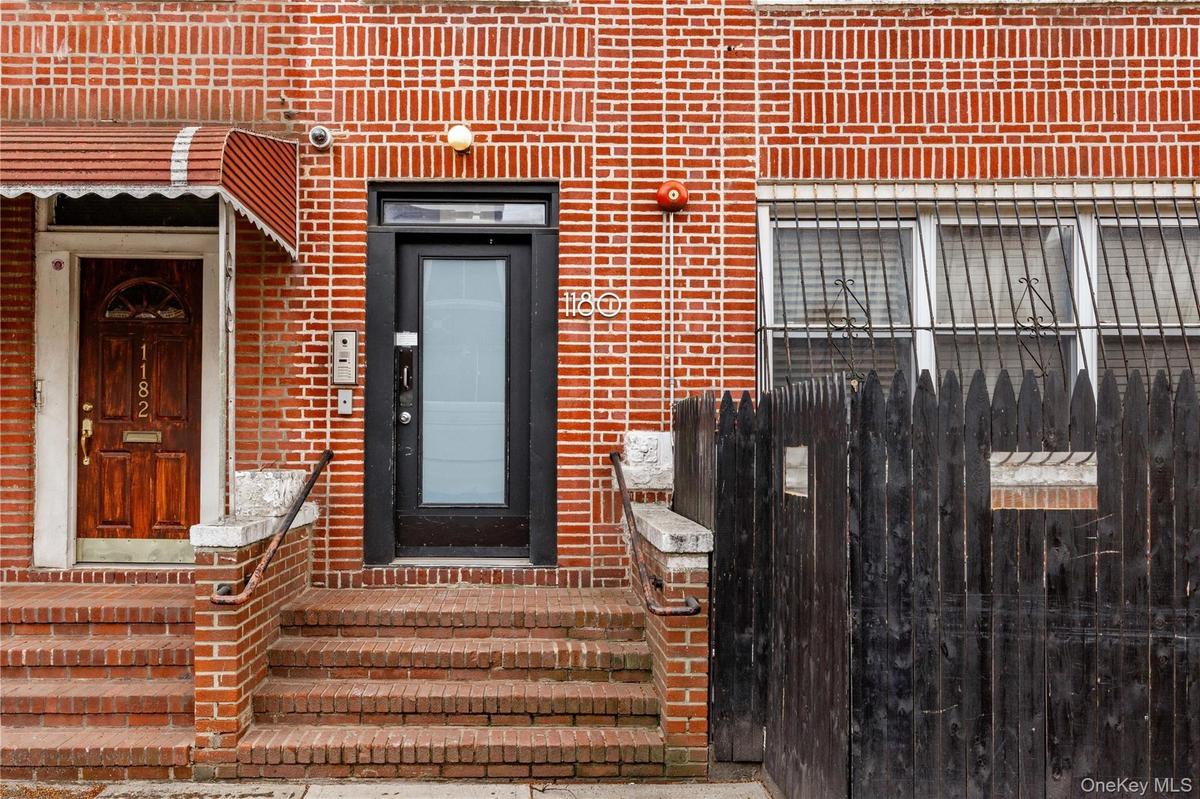 Entrance to property featuring brick siding
