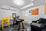 Home office featuring an AC wall unit, a baseboard heating unit, and concrete flooring
