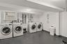 Laundry area with washer and clothes dryer and concrete flooring