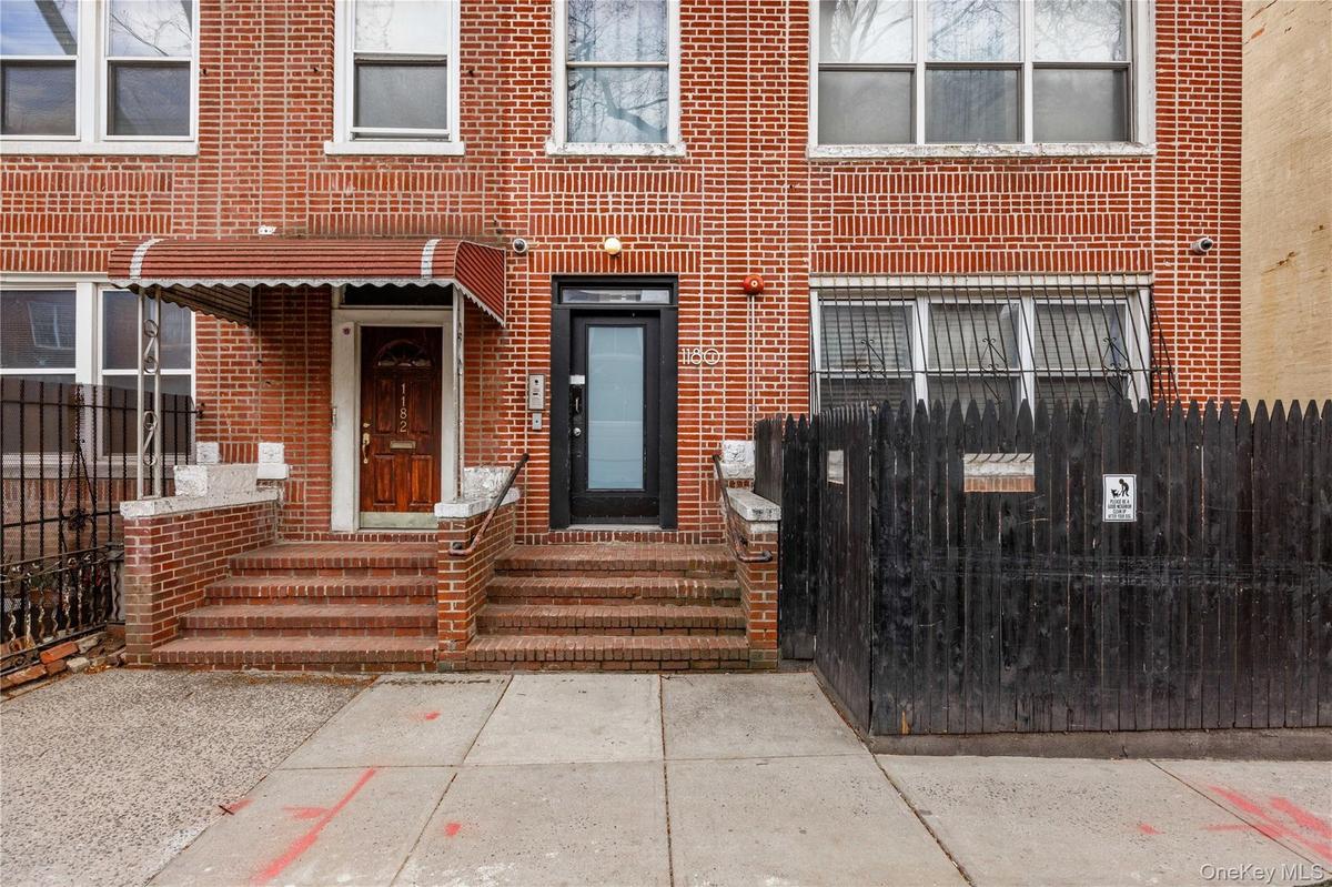 Doorway to property featuring brick siding