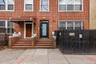 Doorway to property featuring brick siding