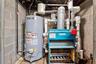 Utilities featuring water heater and a heating unit