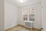 Spare room with radiator heating unit and light wood-type flooring