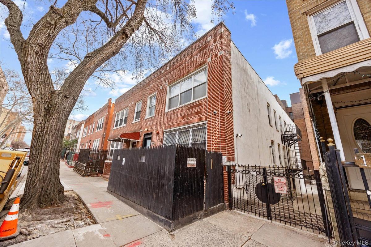 View of building exterior with a fenced front yard
