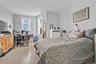 Bedroom featuring a desk, crown molding, and light wood-style flooring