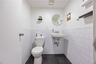 Bathroom featuring a wainscoted wall, tile walls, and tile patterned flooring