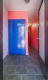 Corridor with brick wall and dark tile patterned floors