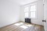 Spare room featuring radiator and light wood-style flooring