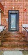 Entrance to property featuring brick siding