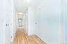Hallway with light wood-style flooring and a baseboard radiator