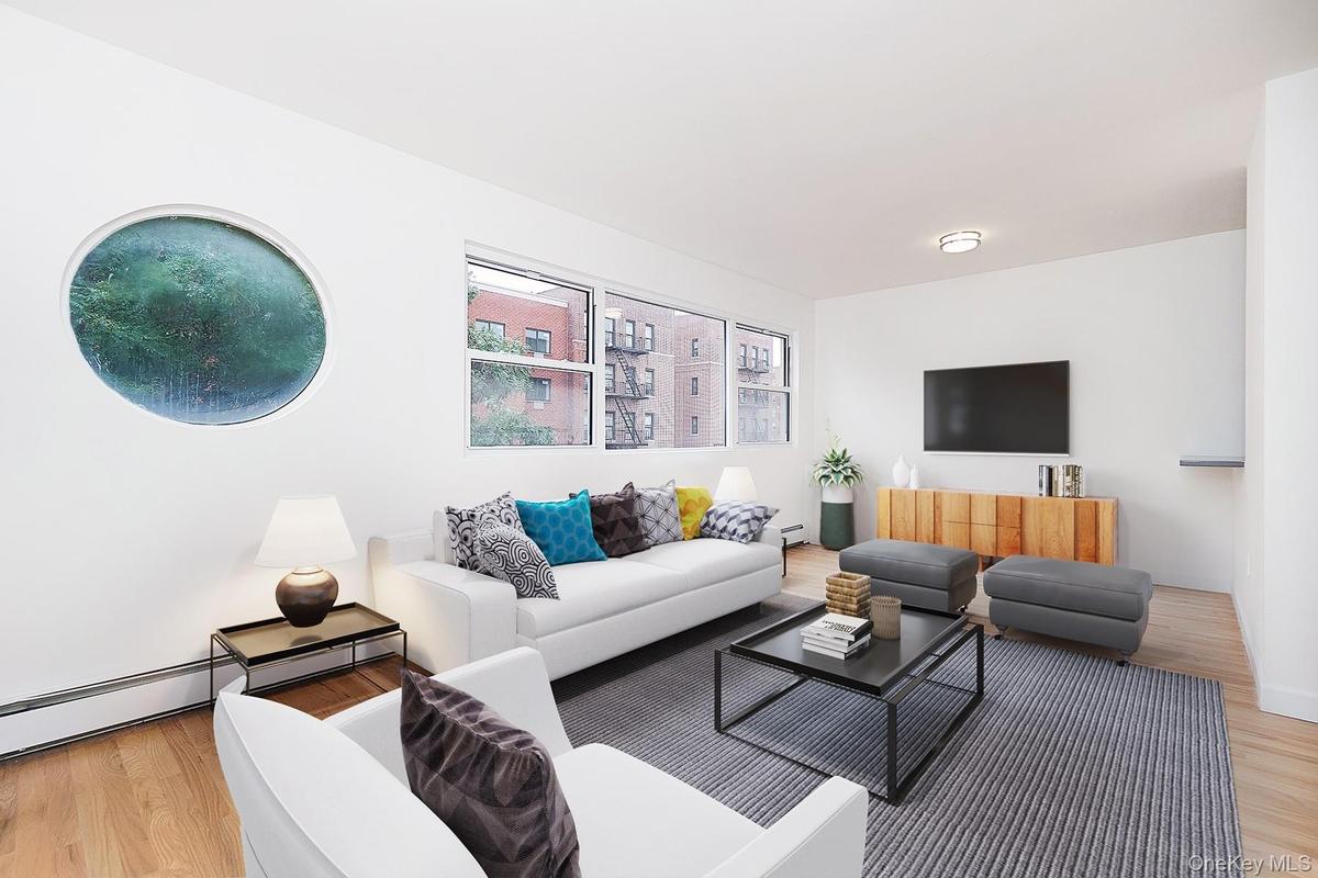 Living area with light wood-style flooring and baseboard heating