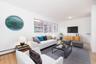 Living area with light wood-style flooring and baseboard heating