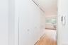 Hallway featuring light wood-style floors and a baseboard heating unit