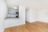 Kitchen featuring gray cabinets, decorative backsplash, light wood finished floors, and stainless steel appliances