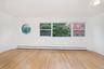 Spare room featuring healthy amount of natural light, light wood finished floors, and a baseboard radiator