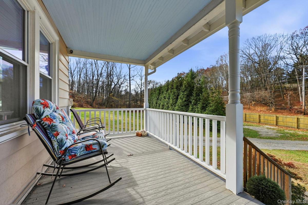 Porch featuring view of scattered trees