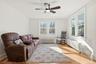 Sitting room featuring radiator, healthy amount of natural light, and light wood-type flooring