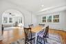 Dining space featuring arched walkways, healthy amount of natural light, light wood-style floors, radiator heating unit, and recessed lighting