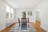 Dining room featuring radiator heating unit, arched walkways, light wood-style flooring, and recessed lighting