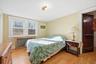 Bedroom featuring radiator and light wood-type flooring