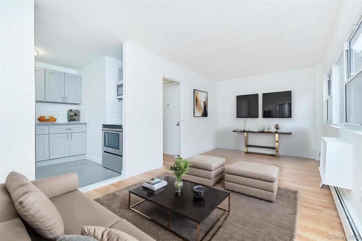 Living area with a baseboard radiator and light wood-style floors