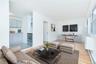 Living area with a baseboard radiator and light wood-style floors
