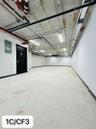 Garage with baseboards and electric panel