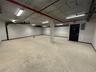 Garage featuring baseboards and electric panel