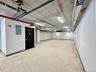 Basement with a garage and electric panel