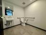 Half bath with baseboards and toilet